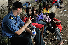 Sub Lieutenant Alexei Wichnevetski, an officer aboard Her Majesty’s Canadian Ship (HMCS) Athabaskan talks to the kids of Leogane, Haiti for OP HESTIA, on the 20 of January 2010.  Photo Corporal Johanie Maheu