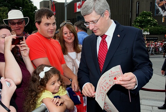Prime Minister with immigrants who received their citizenship.