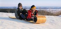 Photo of two children on a toboggan