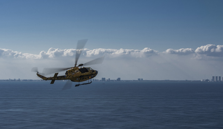 A CH-146 Griffon helicopter flies off after participating in a simulated evacuation off the coast of Miami, Florida during Exercise SOUTHERN BREEZE on February 14, 2017. Photo: Corporal Gary Calvé, Bagotville Imaging section BN07-2017-0500-010