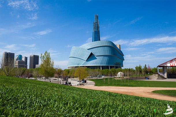 Canadian Museum for Human Rights building, a grassy lawn in the forefront.