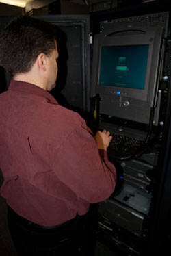 A systems and security specialist at work in the server room