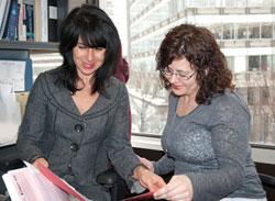 Two financial management employees examining files