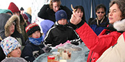 A museum scientist shows Arctic specimens to a group of children and adults.
