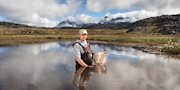 Paul Hamilton stands in a small Arctic lake.