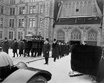 Men carry a coffin outside the museum.