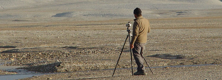 A photographer looking over landscape on Devon Island, Nunavut.