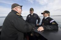 Commander Stephan Ouellet (centre), HMCS Chicoutimi's Commanding Officer, accompanied Her Excellency during her tour of the submarine.