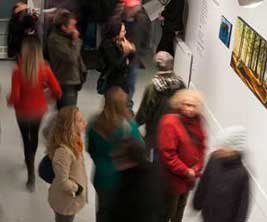 Group of patrons visiting an art gallery on campus.
