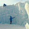 Trois artisans sculptent un mur de glace, en plein hiver.