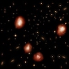 Représentation artistique de lointaines galaxies mises en lumière par le radiotélescope ALMA au Chili.