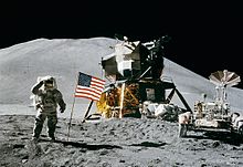 James Irwin on the moon, next to the landing module of Apollo 15 and a lunar rover