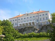 Stenbock House grey stucco three-story building with pediment and portico and red hip roof