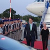 Justin Trudeau marche sur un tapis rouge à sa descente de l'avion. 