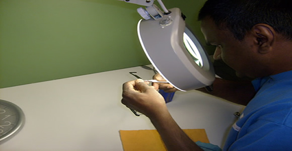 Délinquant Mohan effectue des réparations à  une paire de lunettes