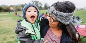 diverse-mom-and-son-enjoying-playing-laughing-outside_t20