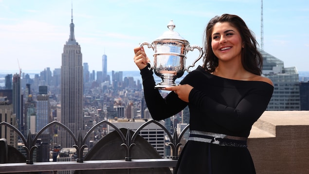 Bianca Andreescu tient le trophée de championne des Internationaux des États-Unis au sommet du Rockefeller Center à New York.