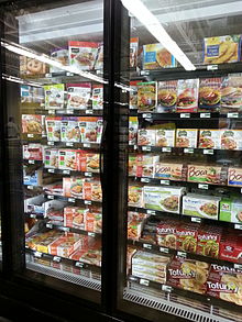supermarket freezer stocked with packaged food
