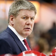 Carolina Hurricanes head coach Bill Peters watches from the bench during the first period of an NHL hockey game between the Carolina Hurricanes and the Colorado Avalanche, Saturday, Feb. 10, 2018, in Raleigh, N.C. (AP Photo/Karl B DeBlaker)