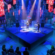 Simulation montrant des personnes assises autour d'une scène sur laquelle joue un groupe de musique.
