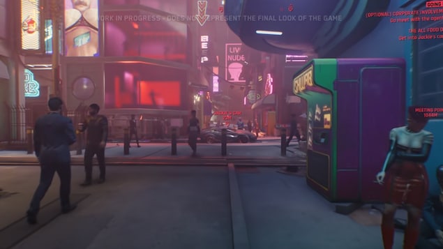 Plusieurs personnes se promènent dans une ville fictive du jeu vidéo Cyberpunk2077.