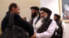 Members of a Afghan Taliban delegation gather to attend the signing of an agreement between the militant groups and U.S. officials in Doha earlier this year. 