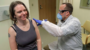 a woman receives a vaccine 