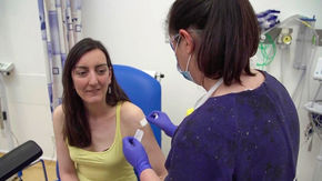 a patient receives a shot in her arm