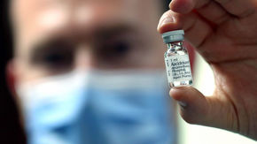 a health care worker holds a bottle of dexamethasone