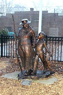 A metal statue of Tubman holding the hand of a small child