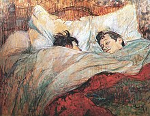 A painting by Henri de Toulouse-Lautrec of two short-haired women in a massive bed, covered to their chins in blankets under a red top cover. One woman is looking sleepily at the other.