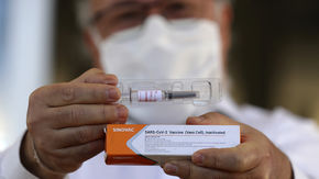 Gustavo Romero displays China’s Sinovac Biotech experimental vaccine for the new coronavirus 