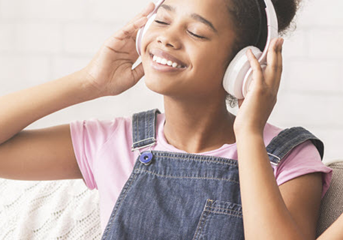 young girl listening to headphones