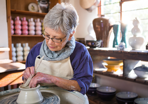 old woman using a pottery wheel