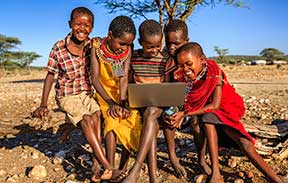 Group of African children using a laptop