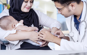 Paediatrician vaccinating baby