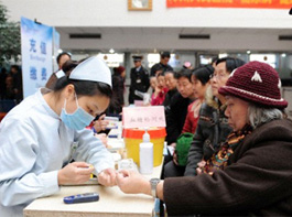 Nurse checks the blood glucose of a senior citizen in Zhengzhou - Copyright: Corbis