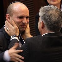 Yair Lapid (R) seen with Naftali Bennett during a plenum session in the Israeli parliament, March 2013 (photo credit: Isaac Harari/Flash90)