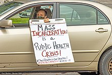 Ohio protester holding a sign saying, "Mass incarceration is a public health crisis"