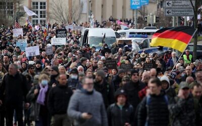 Protesters take part in a march demanding an end to the restrictive coronavirus measures in Kassel, Germany, on March 20, 2021. (Armando Babani/AFP)