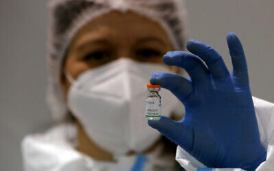 FILE - In this Jan. 19, 2021 file photo, a medical worker poses with a vial of the Sinopharm's COVID-19 vaccine in Belgrade, Serbia (AP Photo/Darko Vojinovic, file)