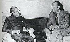 A seated Sheikh Mujibur Rahman and Gerald Ford, smiling and talking