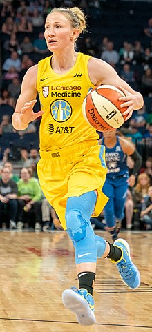 Point guard Courtney Vandersloot in yellow team uniform of the Chicago Sky WNBA team, 2019