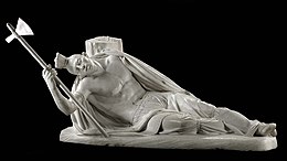 A marble statue showing a wounded Tecumseh on the ground, clutching his axe