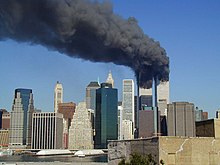 Dark smoke billows from the Twin Towers over Manhattan