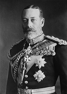 George V is pale-eyed, grey-bearded, of slim build and wearing a uniform and medals