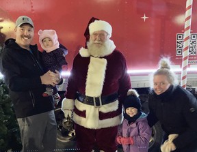 The Martin family - Bill holding Aubrey, Scarlett and mom Nicki - took a moment to pose for a Christmas photo with Santa Claus during the Mitchell BIA street party Dec. 3. SUBMITTED