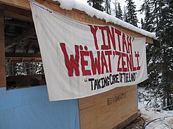 Building at the Unistoten Camp with a banner reading: "Taking Care of the Land"