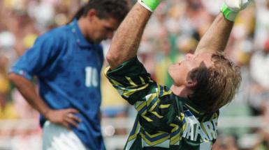 Taffarel celebrates winning World Cup 1994 as Roberto Baggio stands, dejected