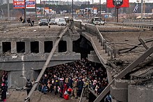 Ukrainian civilians and soldiers take shelter under a bridge in Kyiv.jpg